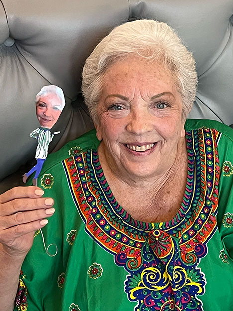 A senior resident with their puppet self.